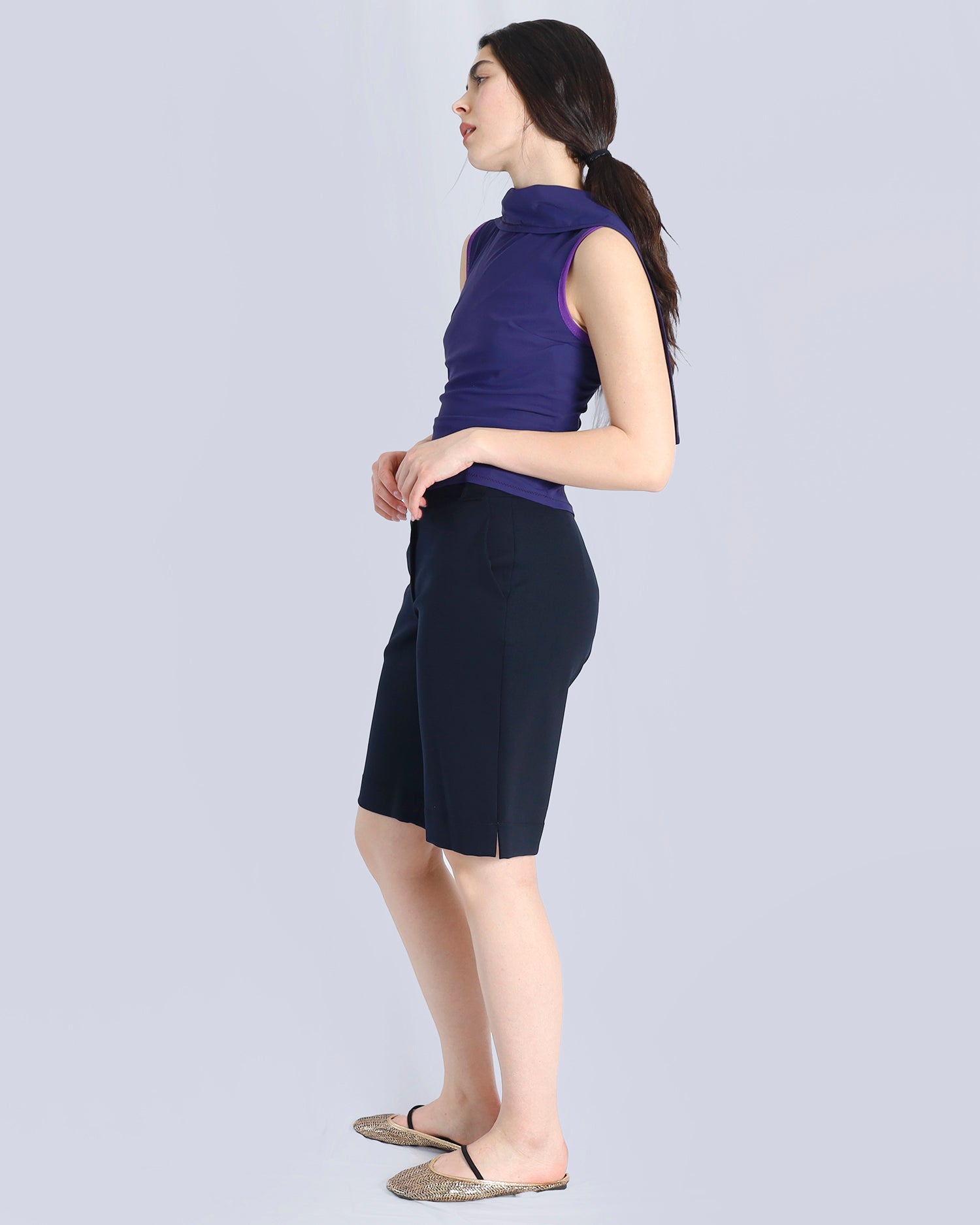 Woman wearing a purple sleeveless top and black shorts on a light gray background. Maison Marie Saint Pierre | Pants | AVALON2 | Black | Top | PAYTON | Hunter 
