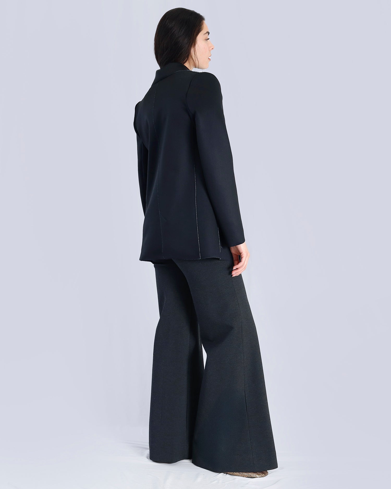 Person wearing a black suit with wide-leg pants on a light gray background. Maison Marie Saint Pierre | Pants | AVALON2 | GMI | Jacket | PAOLO2 | Black Wisteria Macro | Top | PAYTON | HUN
