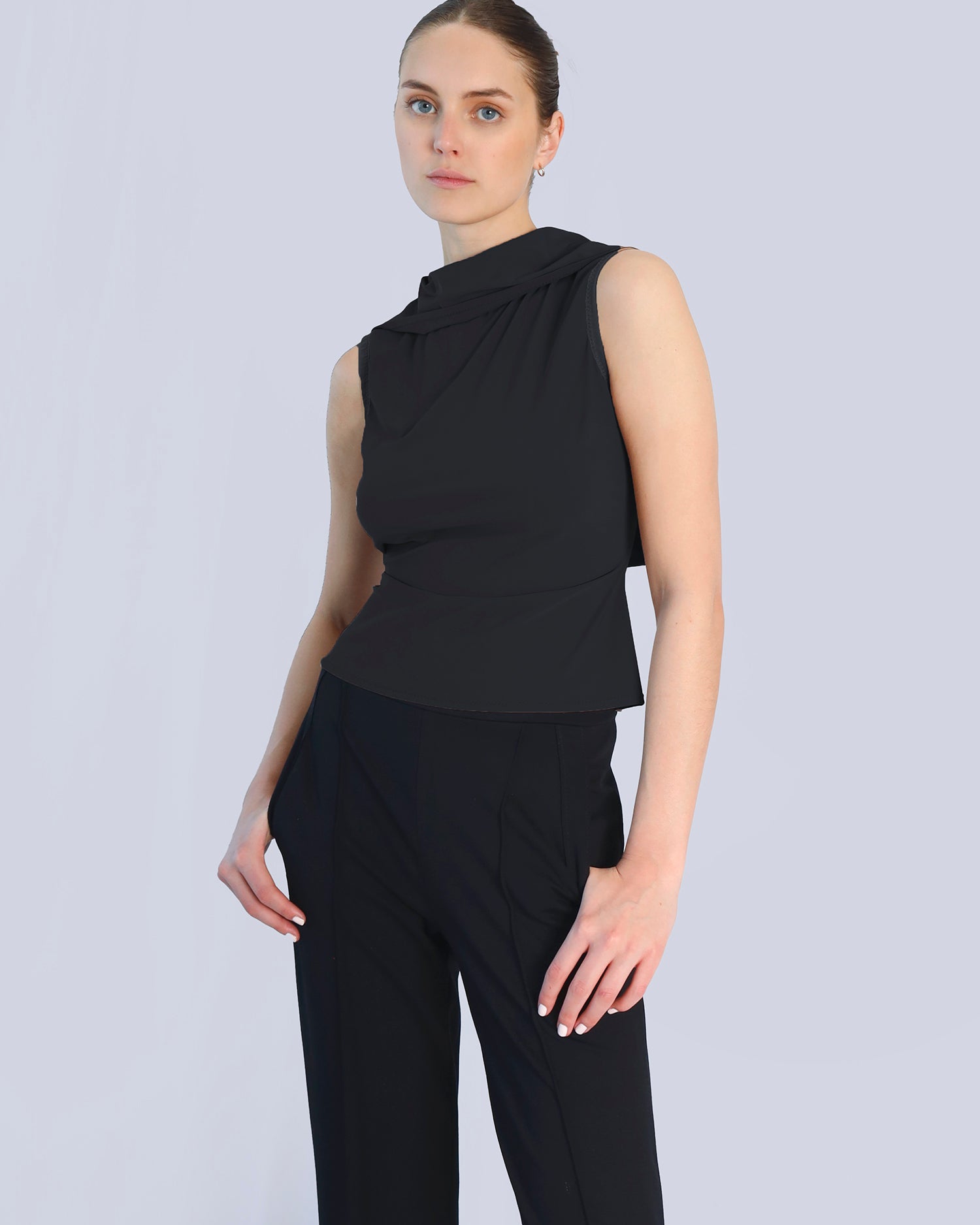 Woman wearing a black sleeveless top and pants on a light gray background. Maison Marie Saint Pierre | Pants | DELMIRA2 | Black | Top | PAYTON | Black 