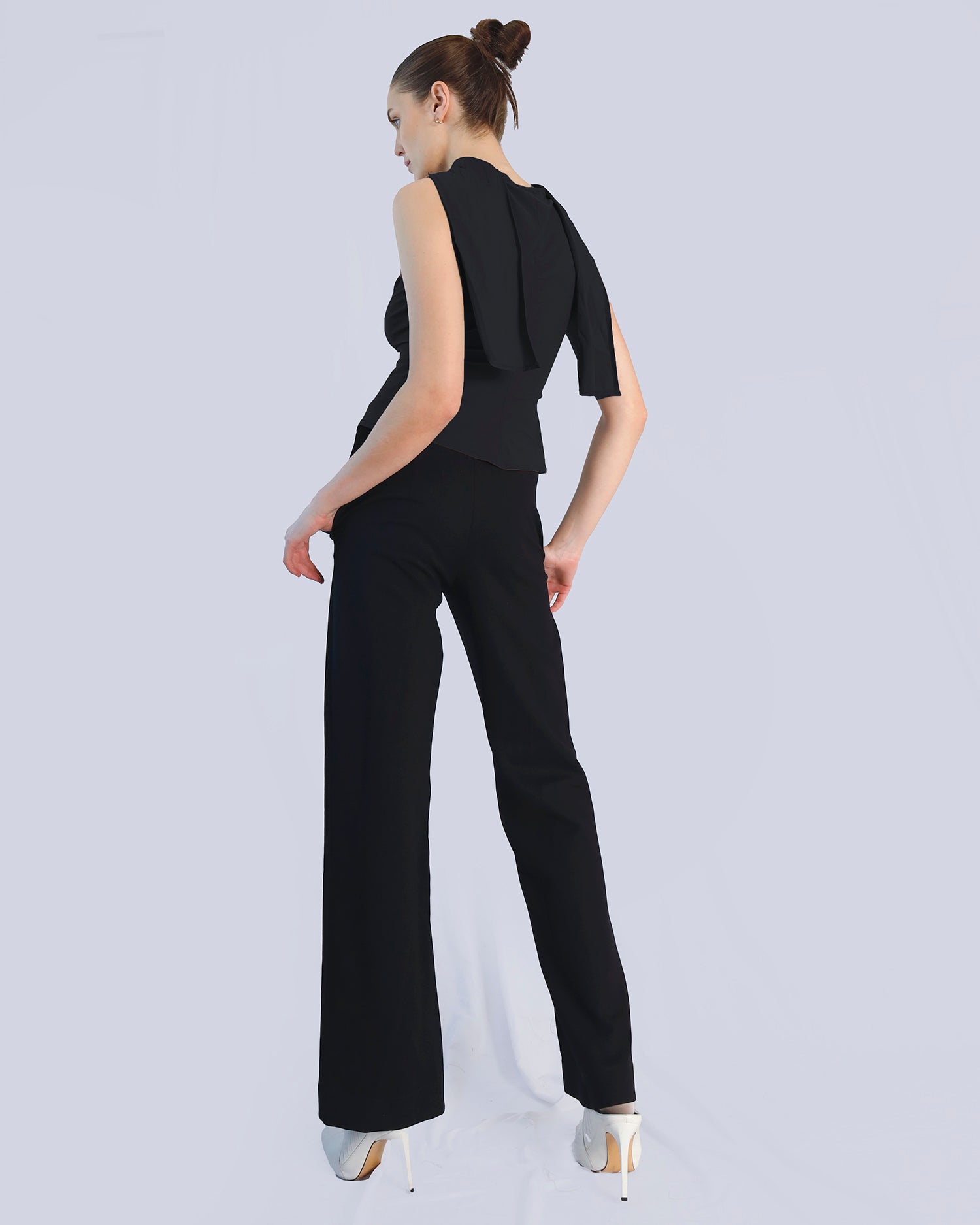Woman wearing a black sleeveless top and wide-leg pants on a light gray background. Maison Marie Saint Pierre | Pants | DELMIRA2 | Black | Top | PAYTON | Black 