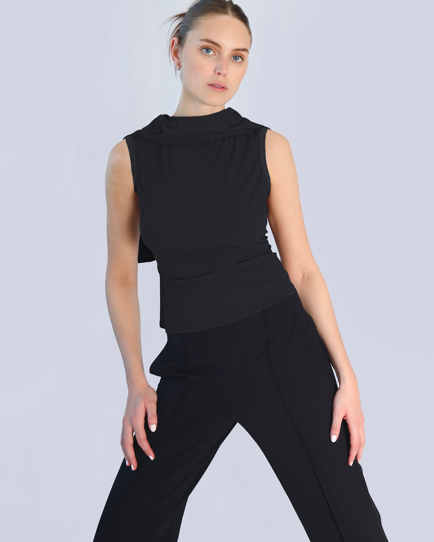 Woman wearing a black sleeveless top and pants on a light gray background. Maison Marie Saint Pierre | Pants | DELMIRA2 | Black | Top | PAYTON | Black 
