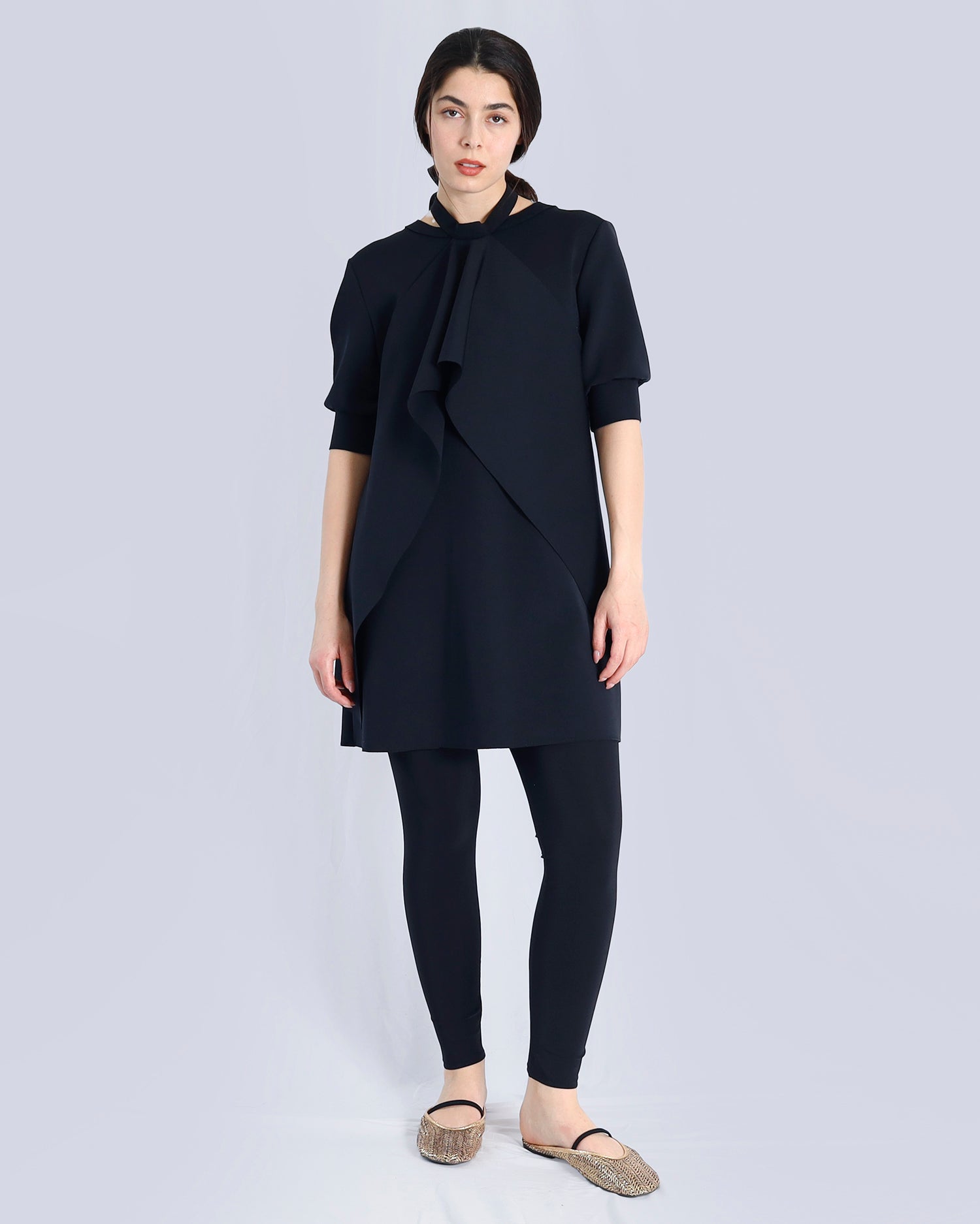 Woman wearing a black outfit on a light gray background. Maison Marie Saint Pierre | Dress | PAVO | Black | Pants | ESSANY | Black 