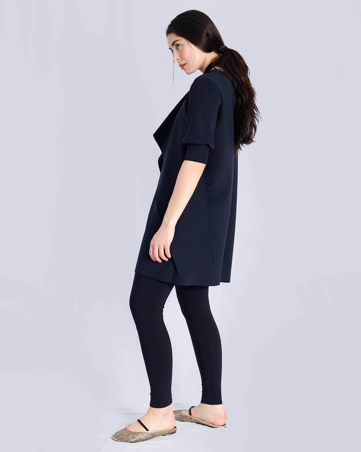 Woman wearing a black outfit on a light gray background. Maison Marie Saint Pierre | Dress | PAVO | Black | Pants | ESSANY | Black 