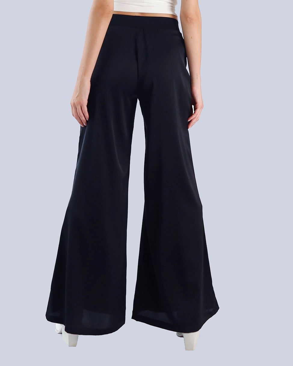 Black wide-leg pants worn by a person on a light gray background. Maison Marie Saint Pierre | Pants | PAMELA | Black 
