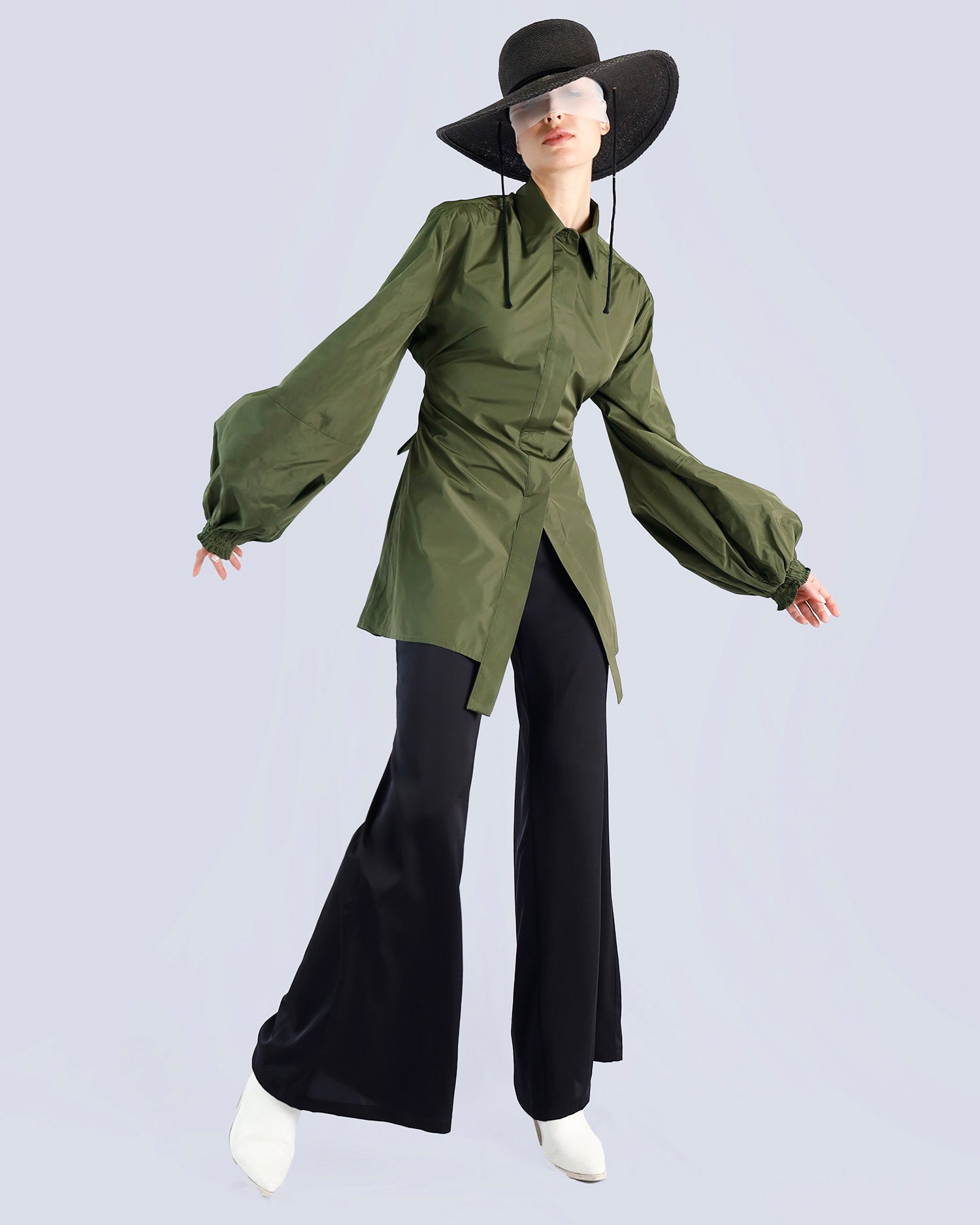 Person wearing a green shirt and black pants with a wide-brimmed hat on a light gray background. Maison Marie Saint Pierre | Pants | PAMELA | Black | Top | PALMEDI | Kaki