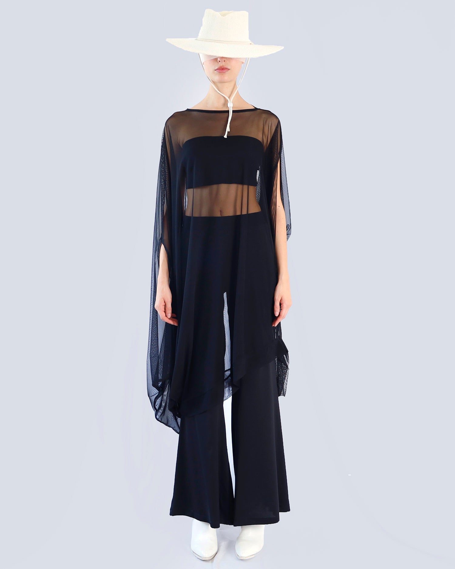 Person wearing a black outfit with sheer sleeves on a light gray background. Maison Marie Saint Pierre | Dress | PHASMINA | Black | Pants | PAMELA | Black