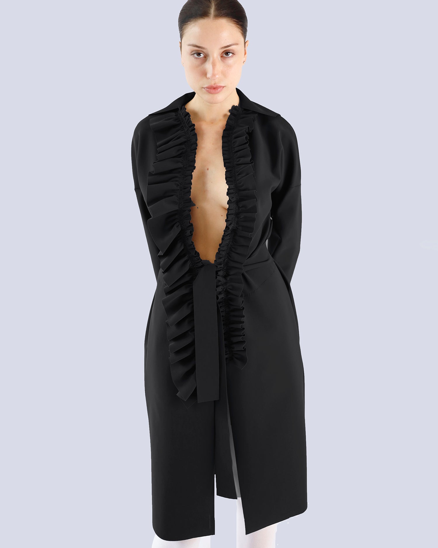 Woman wearing a black dress with ruffled details on a light gray background. Maison Marie Saint Pierre | Coat | PELLINAME | ANT | Pants | PALLAS | Black 