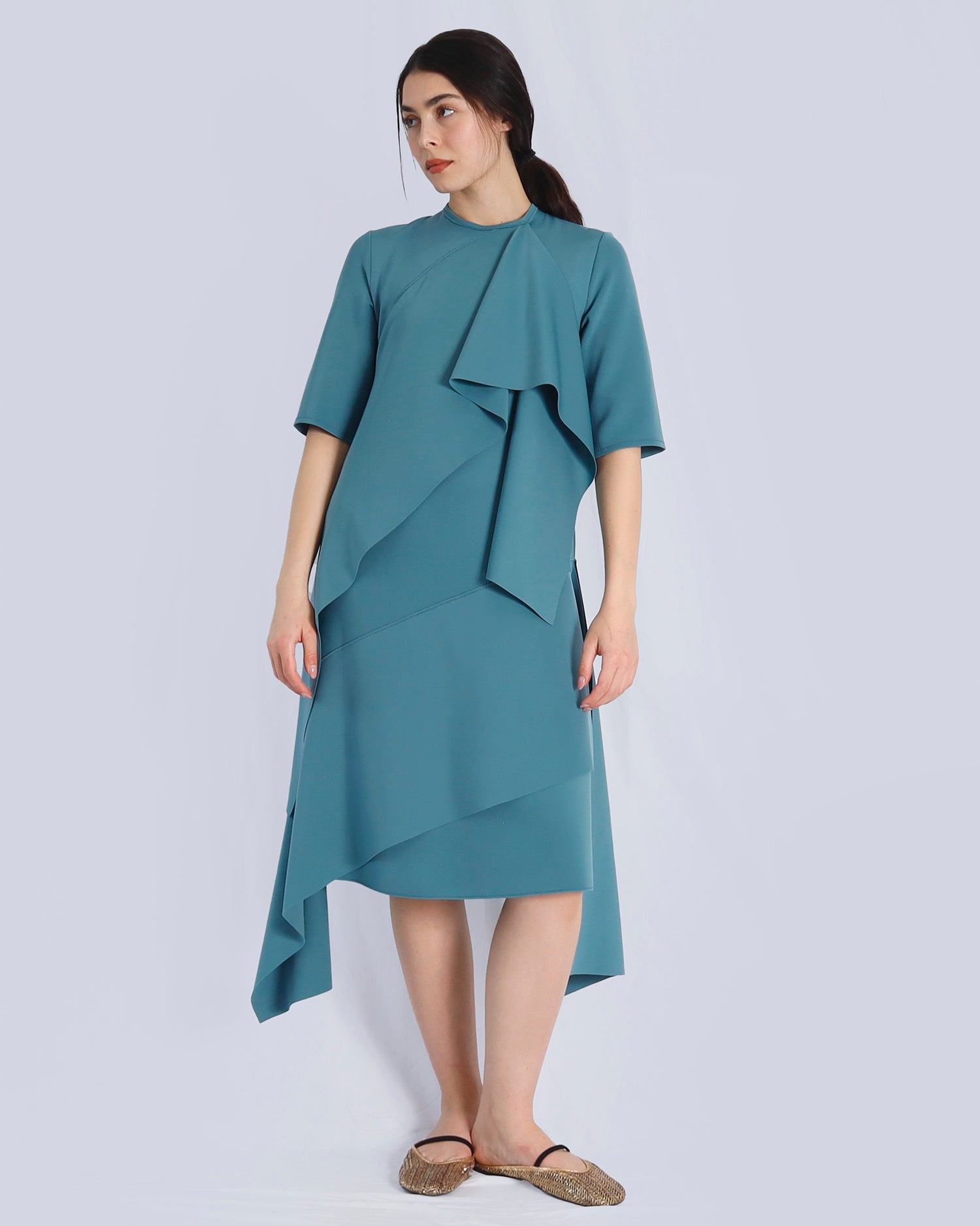 Woman wearing a teal dress with ruffled details on a light gray background. Maison Marie Saint Pierre | Dress | PRISCA | Conifer