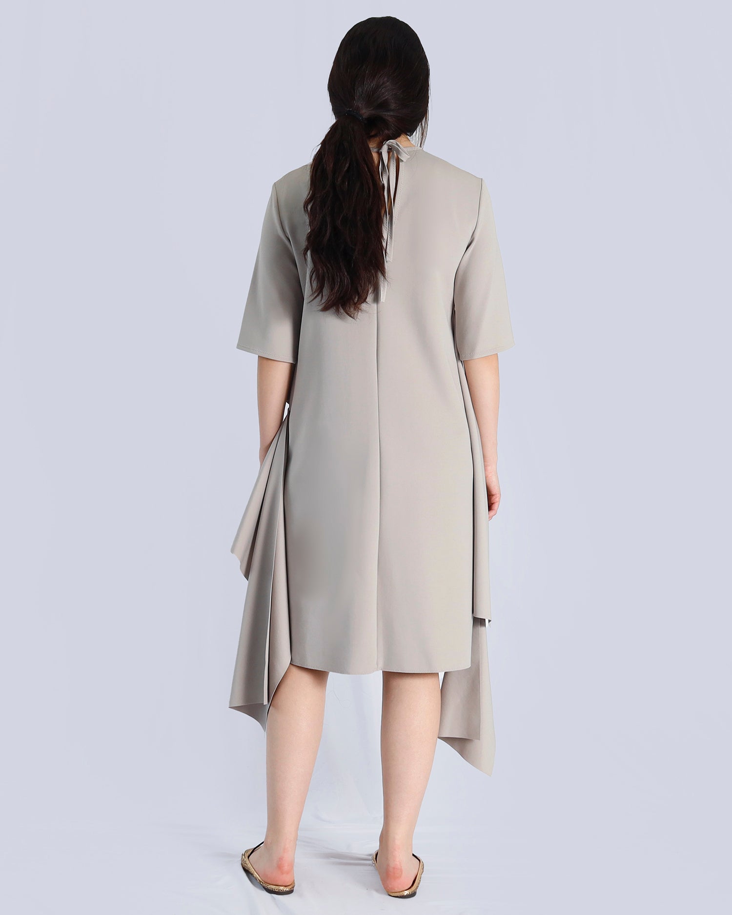 Woman wearing a beige dress with a plain background. Maison Marie Saint Pierre | Dress | PRISCA | Fog