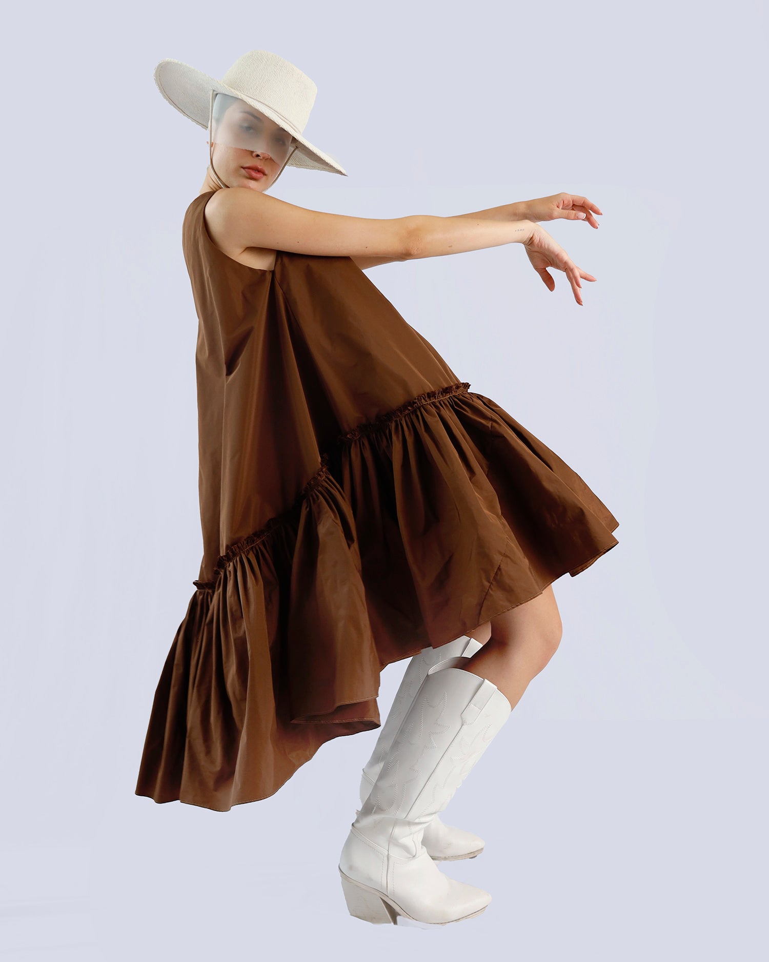 Person wearing a brown dress and white boots with a plain background. Maison Marie Saint Pierre | Dress | PENSEE |  Dark Umber 