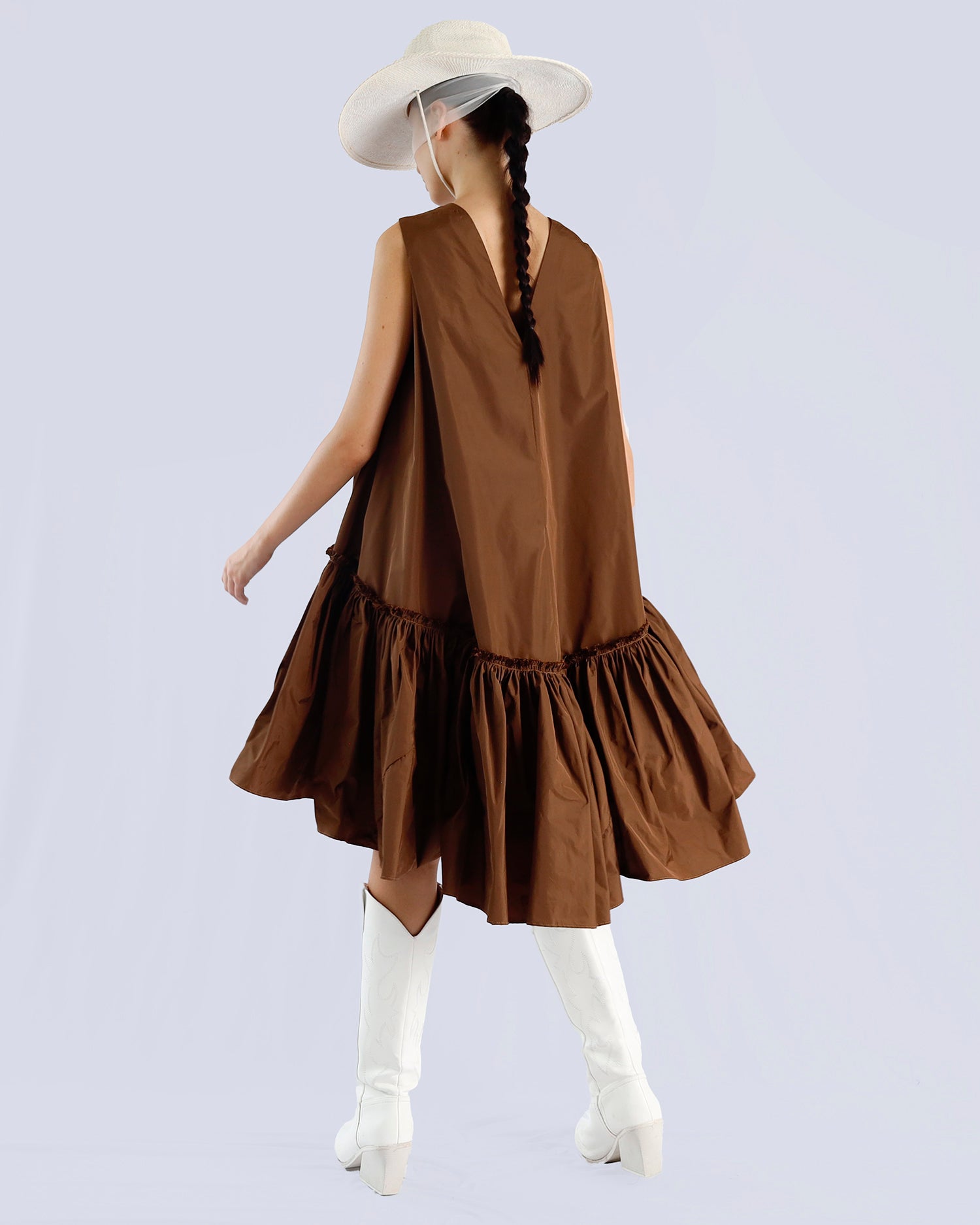 Woman wearing a brown dress with ruffled layers on a light gray background. Maison Marie Saint Pierre | Dress | PENSEE |  Dark Umber 