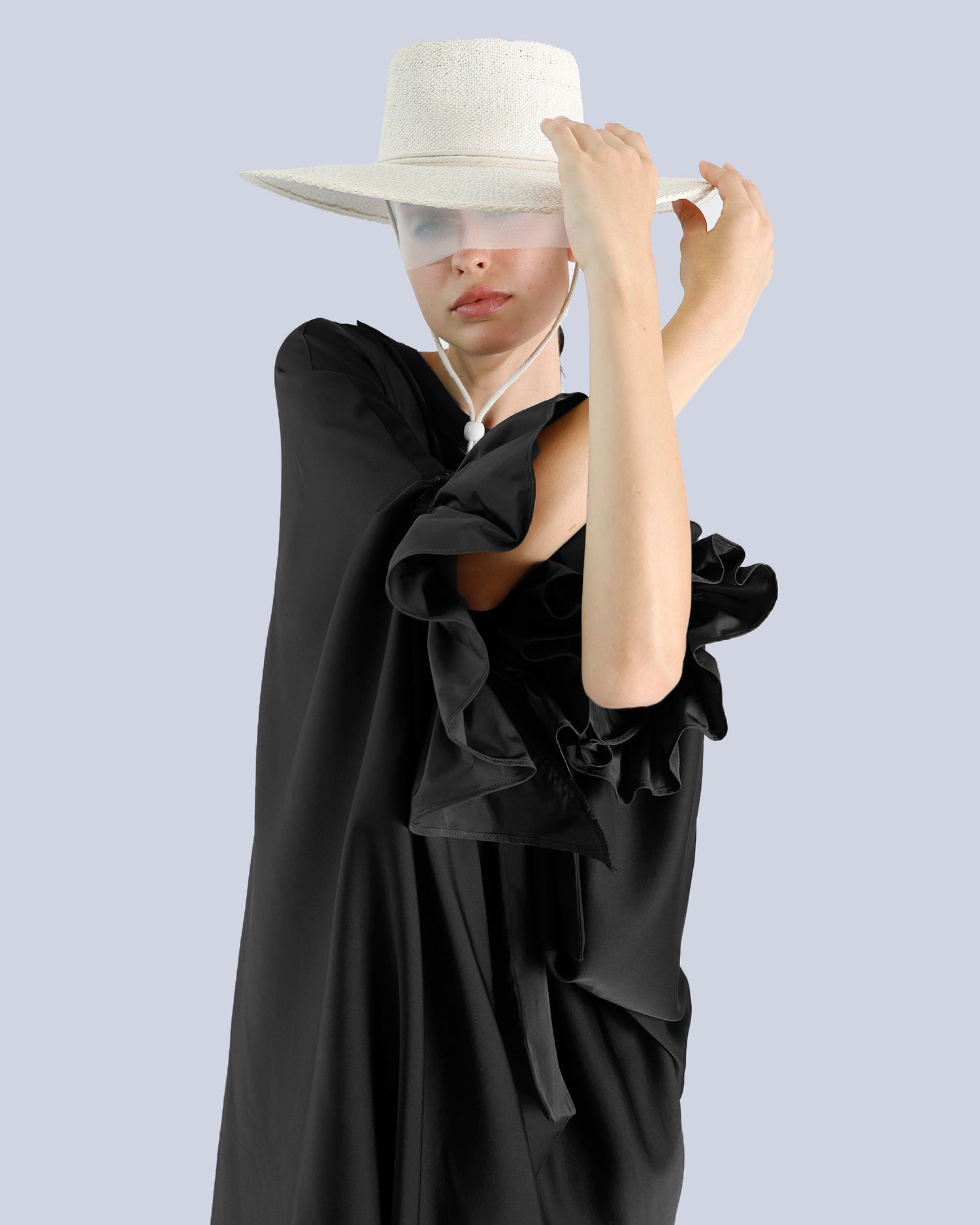 Person wearing a black dress and white hat against a light gray background. Maison Marie Saint Pierre | Dress | PHASME | Black 