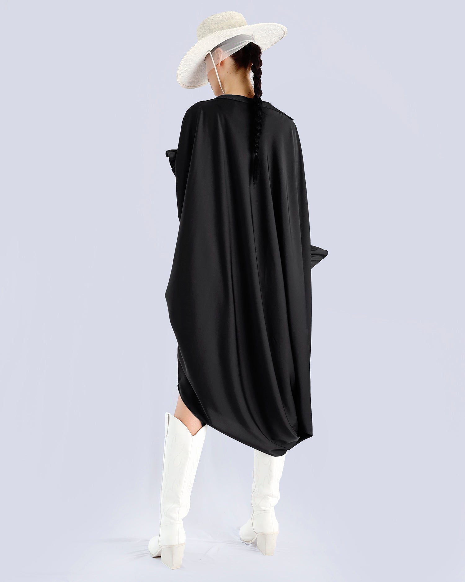 Person wearing a black dress, white boots, and a wide-brimmed hat on a light gray background. Maison Marie Saint Pierre | Dress | PHASME | Black 