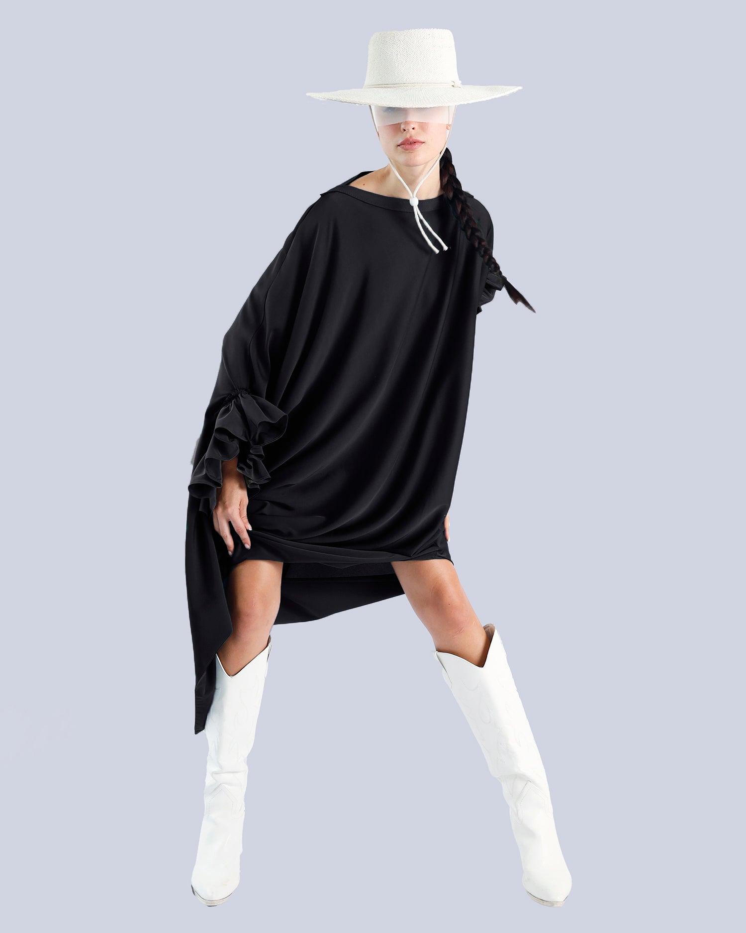 Person wearing a black dress with ruffled sleeves and white boots on a light gray background. Maison Marie Saint Pierre | Dress | PHASME | Black 