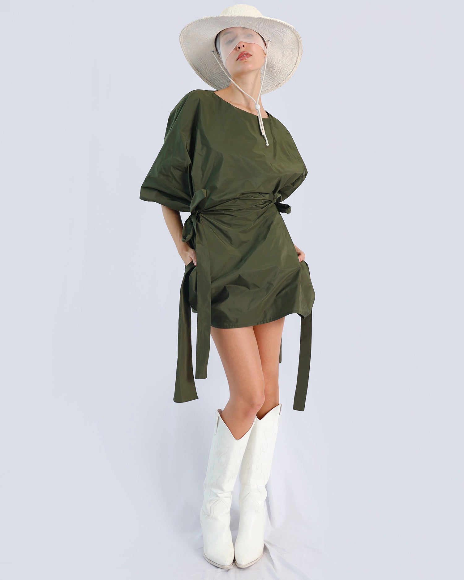 Person wearing a green dress with a white hat and white boots on a light gray background. Maison Marie Saint Pierre | Dress | PHAENNE |  Kaki