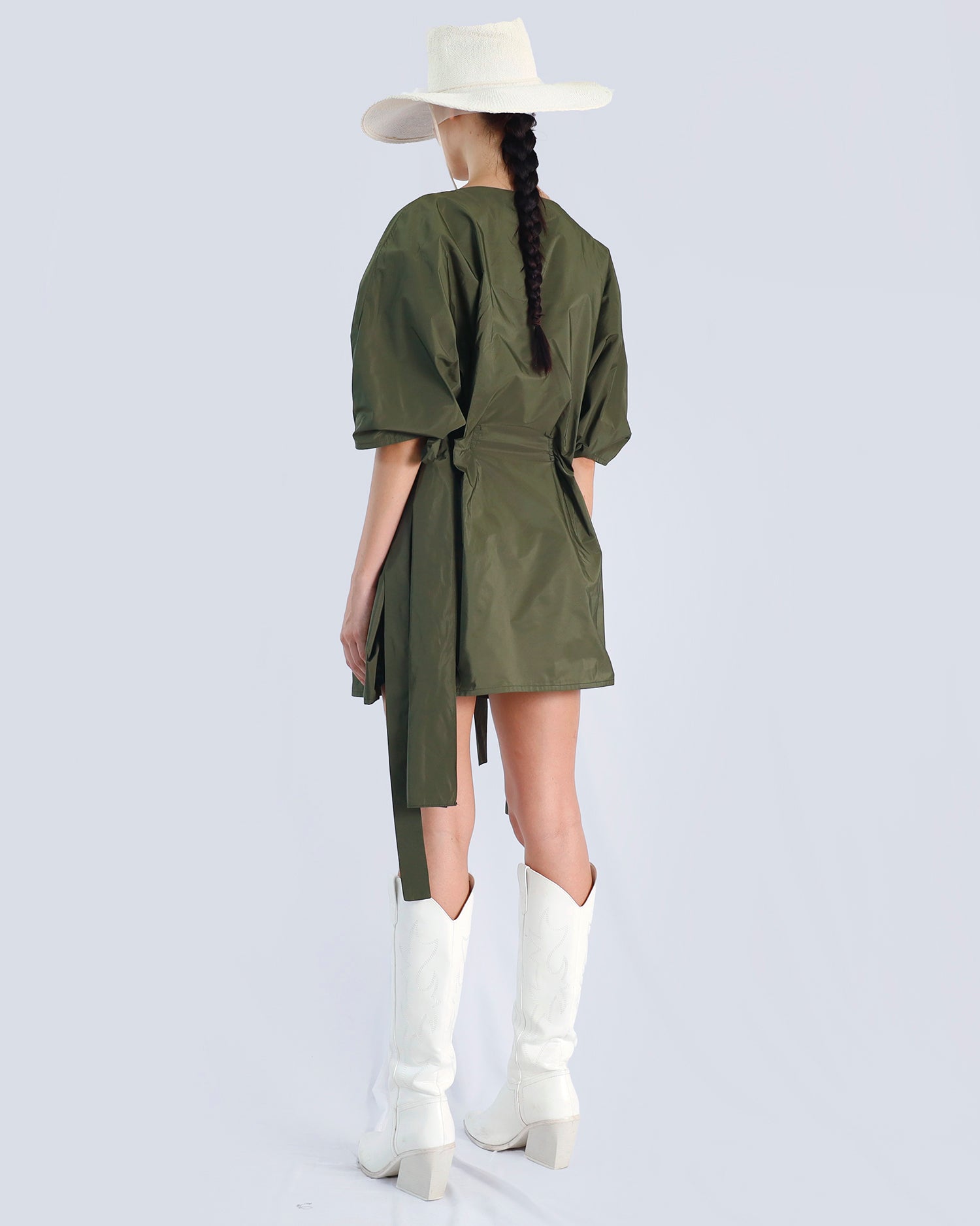Person wearing an olive green dress with a wide-brimmed white hat and white boots on a light gray background. Maison Marie Saint Pierre | Dress | PHAENNE |  Kaki