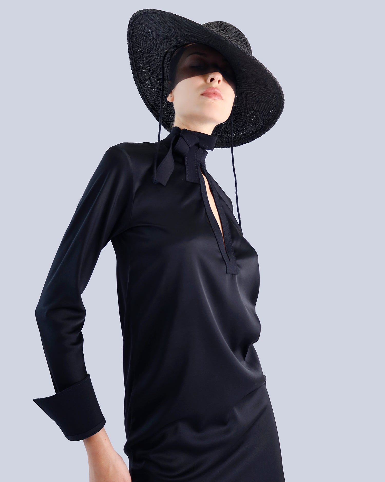 Mannequin wearing a black dress with a wide-brimmed hat on a light gray background. Maison Marie Saint Pierre | Dress | PATTI | Black 