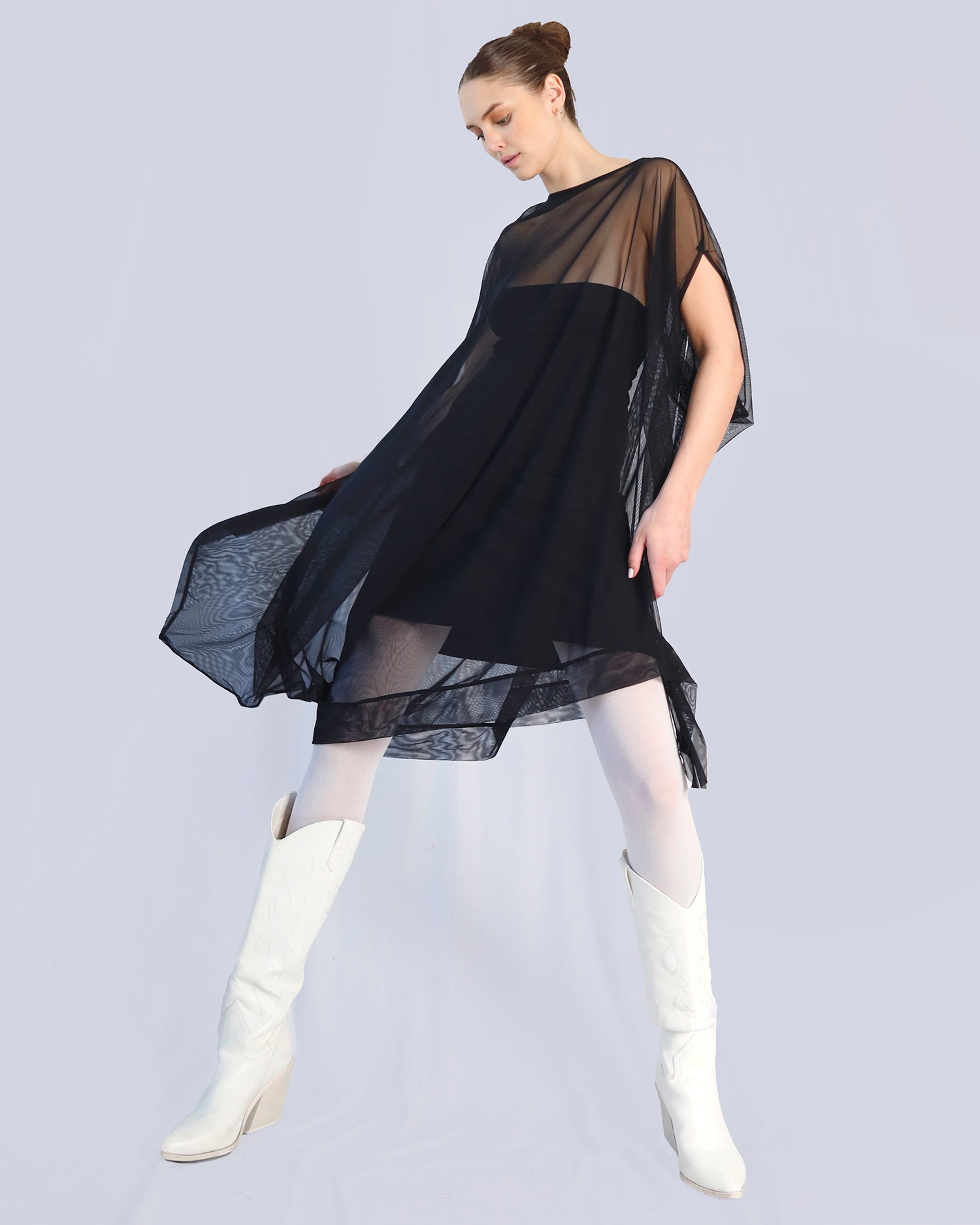 Woman wearing a black dress with sheer overlay and white knee-high boots on a light gray background. Maison Marie Saint Pierre | Dress | PHASMINA | Black