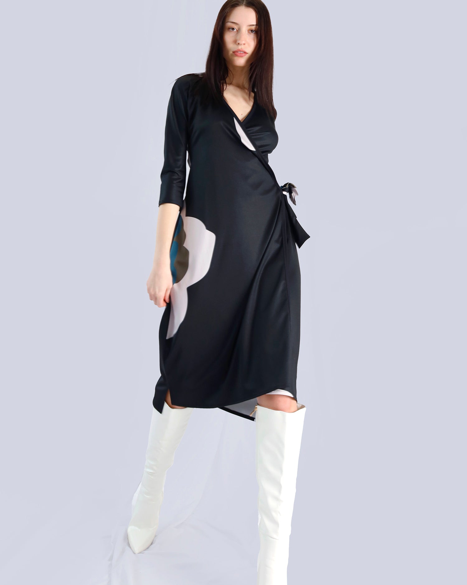 Woman wearing a black dress with white patterns and white knee-high boots on a light gray background. Maison Marie Saint Pierre | Dress | PAISLEY | Black Wisteria Macro